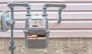gas meter and gas line outside pink house