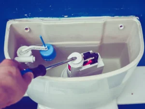 Homeowner fixing toilet that constantly runs